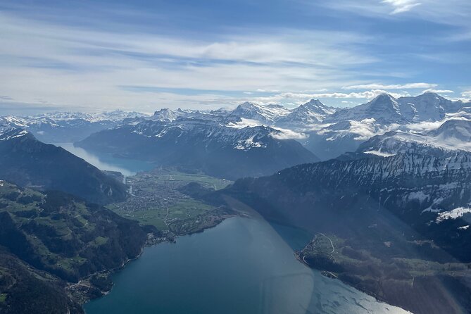 Private Swiss Alps helicopter tour over snow covered mountain peaks and glaciers - The Eiger north face from the cockpit