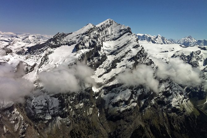 Private Swiss Alps helicopter tour over snow covered mountain peaks and glaciers - The private group format and seat value
